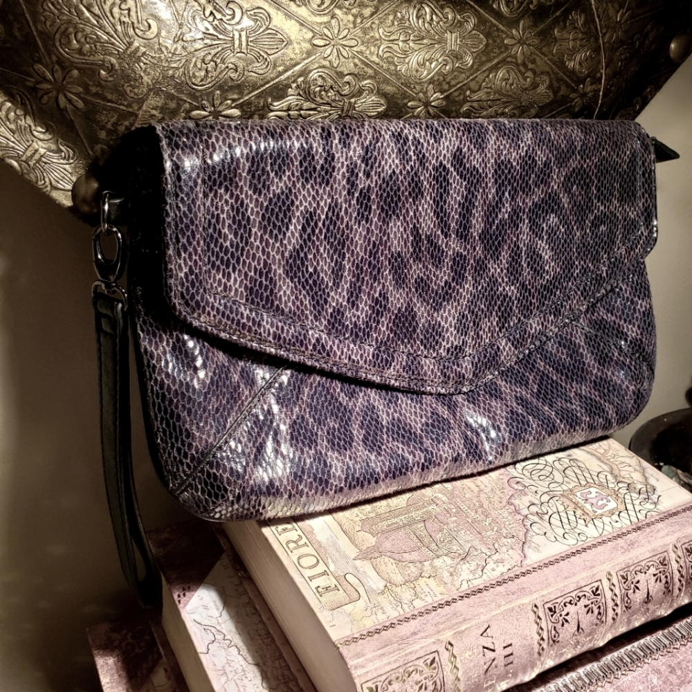 Faux snakeskin wristlet clutch.